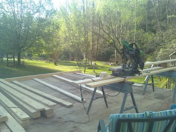 Miter saw and framing lumber on a deck under construction in Limerick